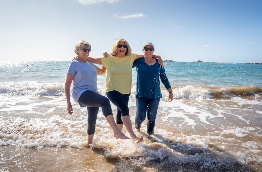 A group of happy senior enjoys a fun outing at a local beach in Santa Rosa Beach.